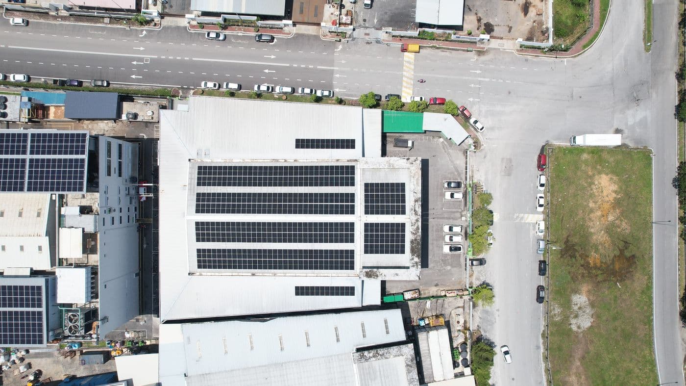 Top-down view of the Harvest Group building with rows of rooftop solar panels
